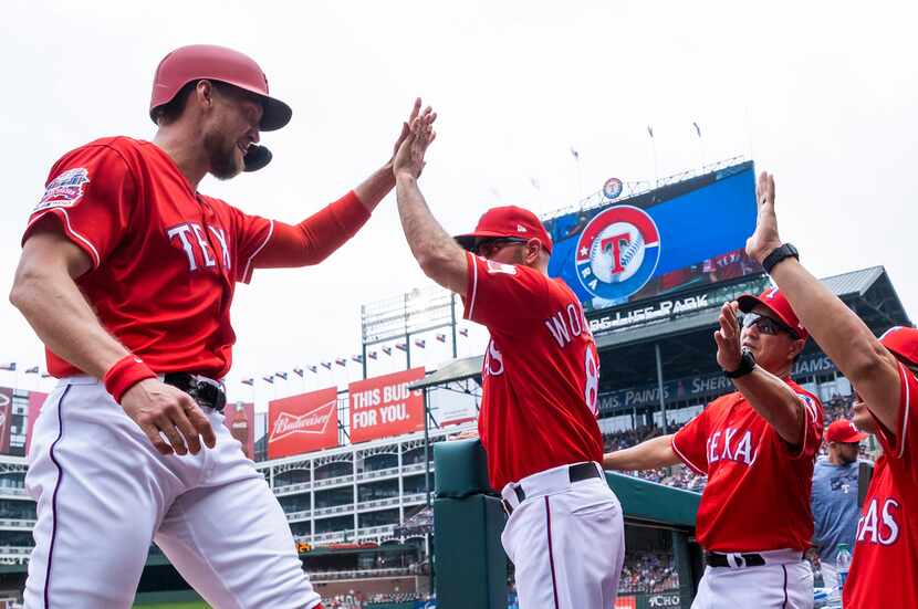 Texas Rangers designated hitter Hunter Pence (24) celebrates with manager Chris Woodward...