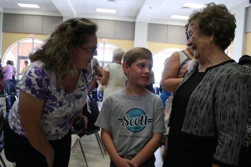 
Dallas Academy seventh-graders Joshua Hargrove (left) and Virginia Addison explain the...