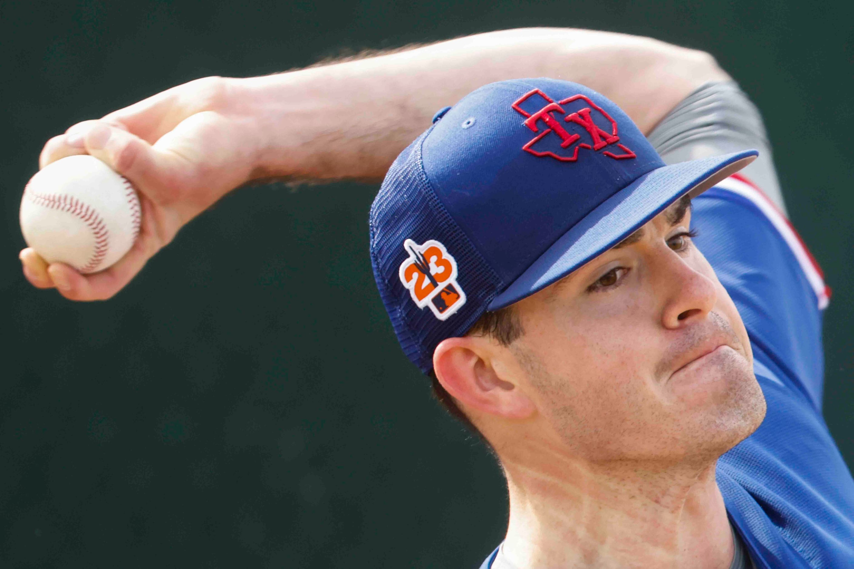 Texas Rangers pitcher Cody Bradford throws a pitch during a spring training workout at the...