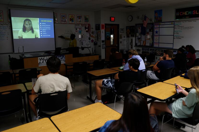 Students watch as a video is played during a STOPit presentation at Frisco Lone Star High...