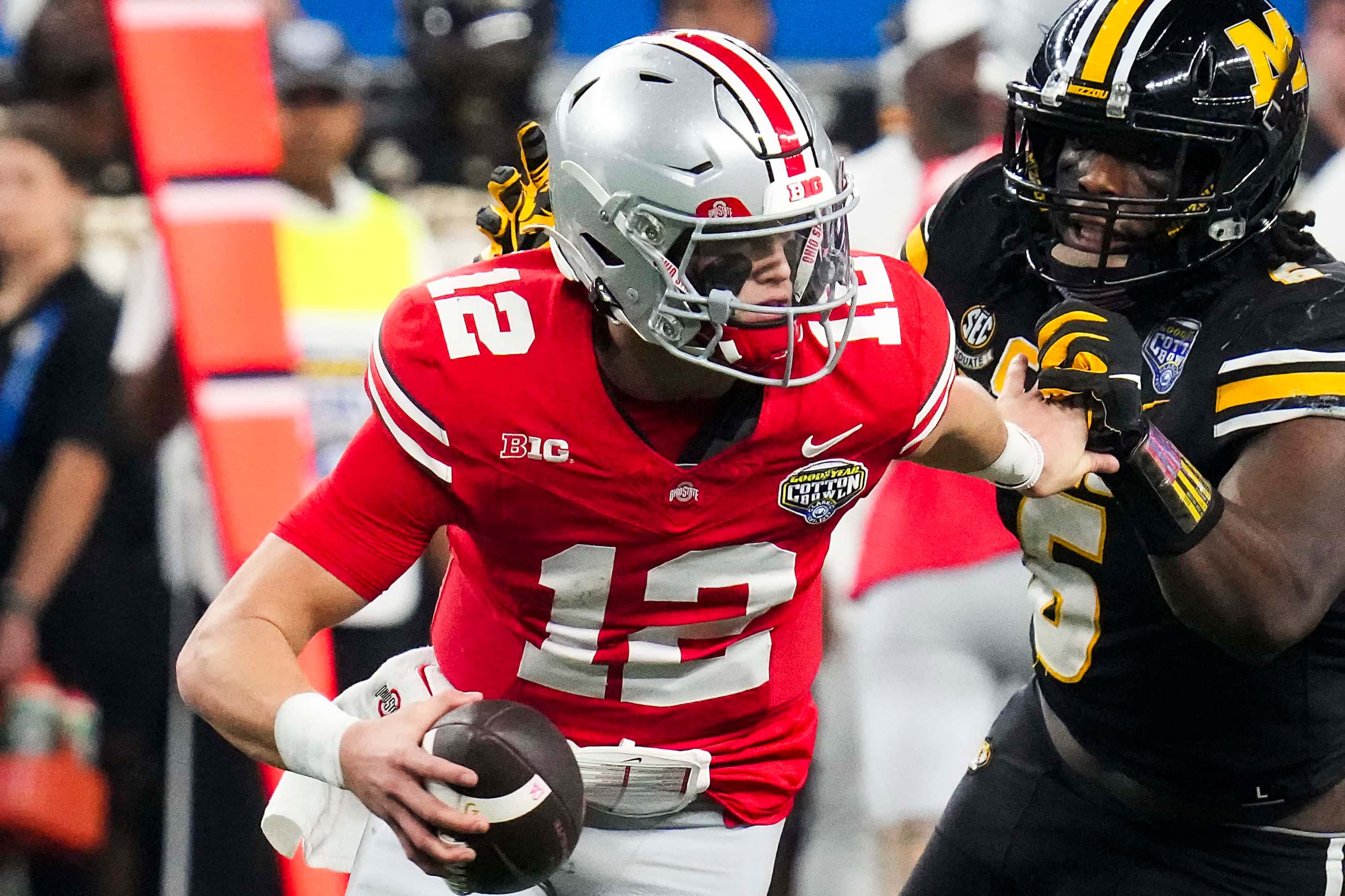 Ohio State quarterback Lincoln Kienholz (12) is chased out of the pocket by Missouri...
