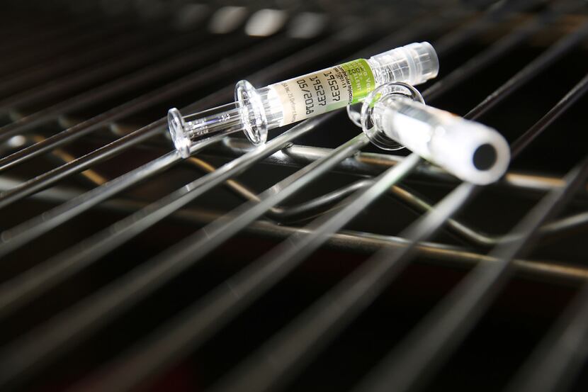 Two influenza vaccine vials are photographed at a mobile immunization clinic hosted by...
