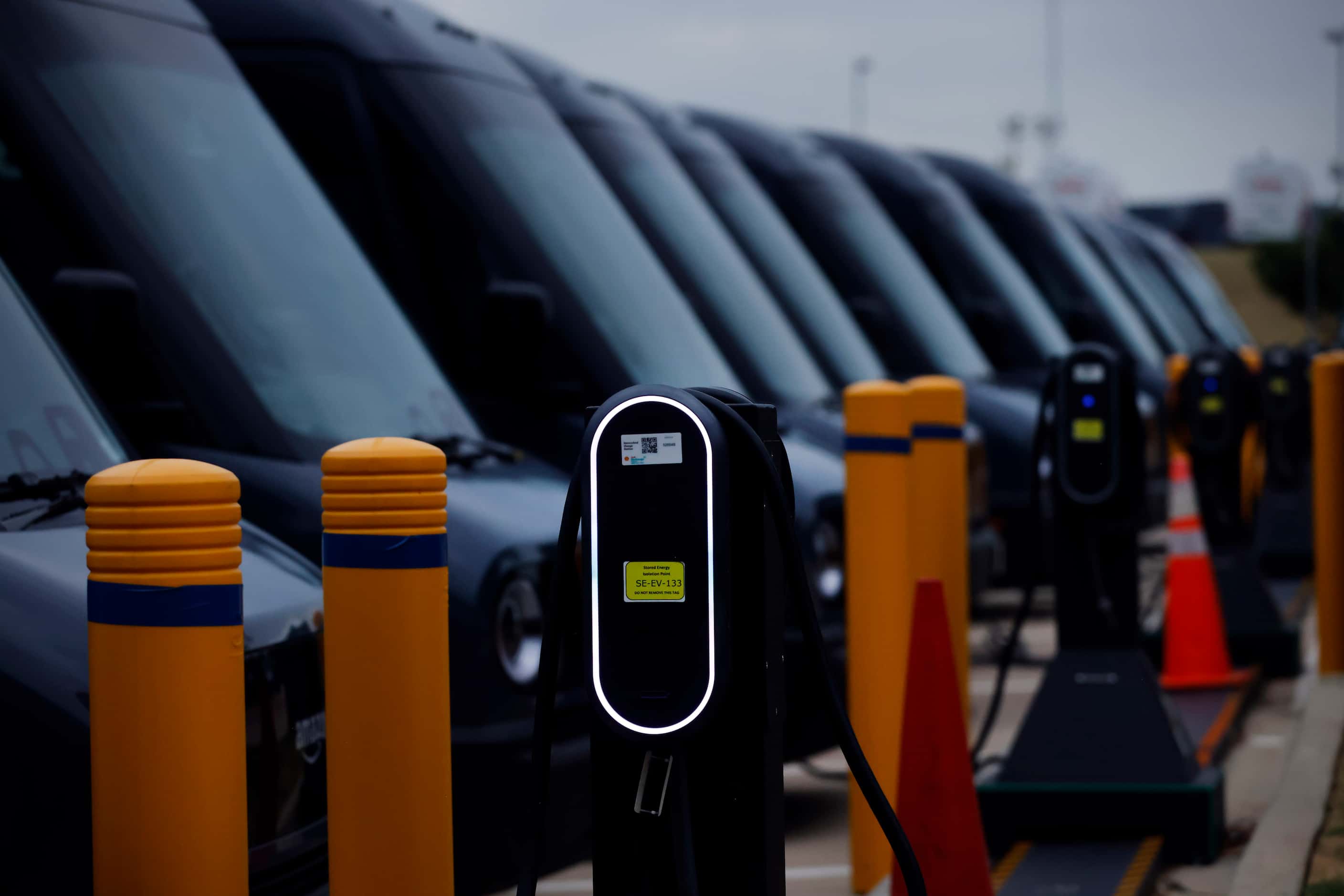 Some of the 70 Amazon Electronic Delivery Vehicles (EDV) charge at one of the country’s...