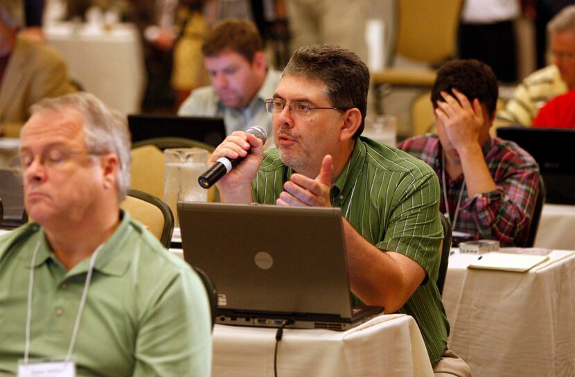 Dallas Morning News sportswriter Chuck Carlton (center) asks a question during  Big 12 Media...