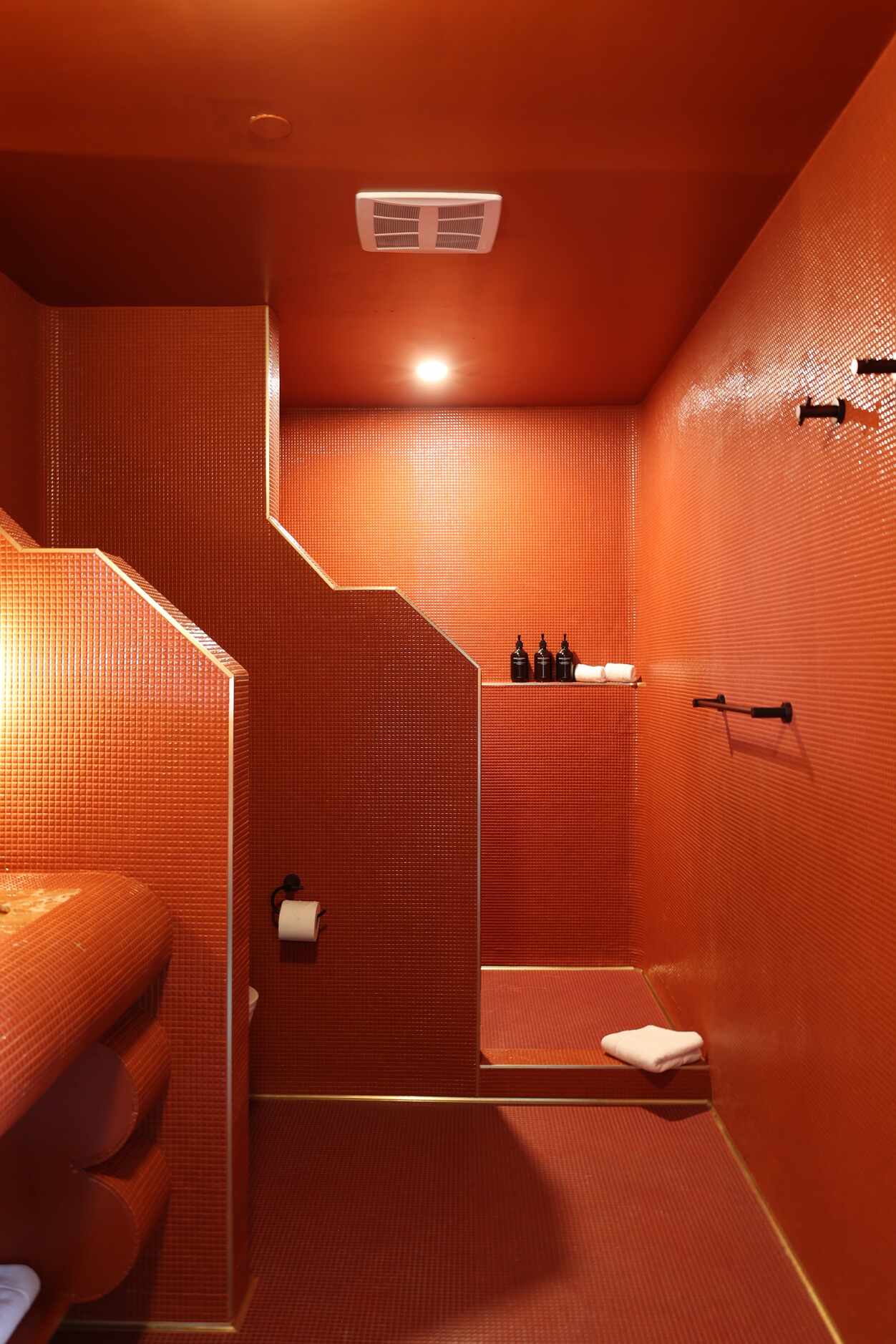 The bathrooms at Hotel Herringbone are monochromatic, designed floor to ceiling with tiny...