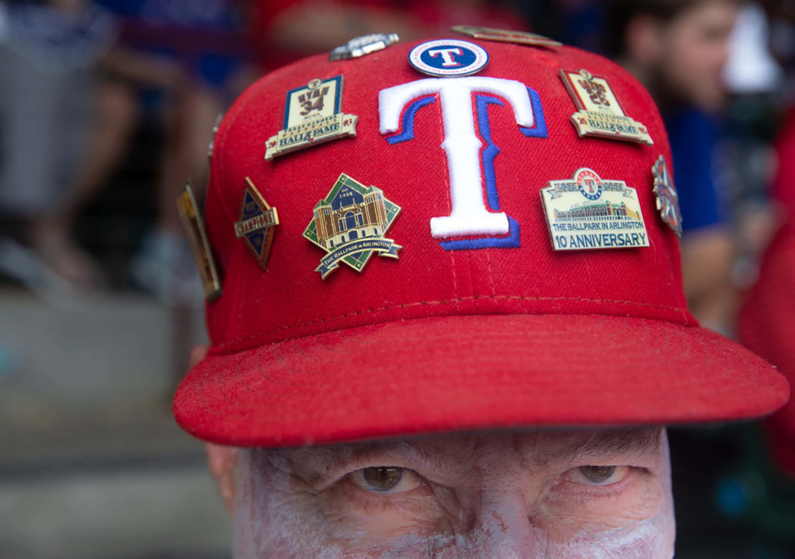 Jim Perkins, from Dallas, shows his collection of Texas Rangers hat pins during the Rangers'...