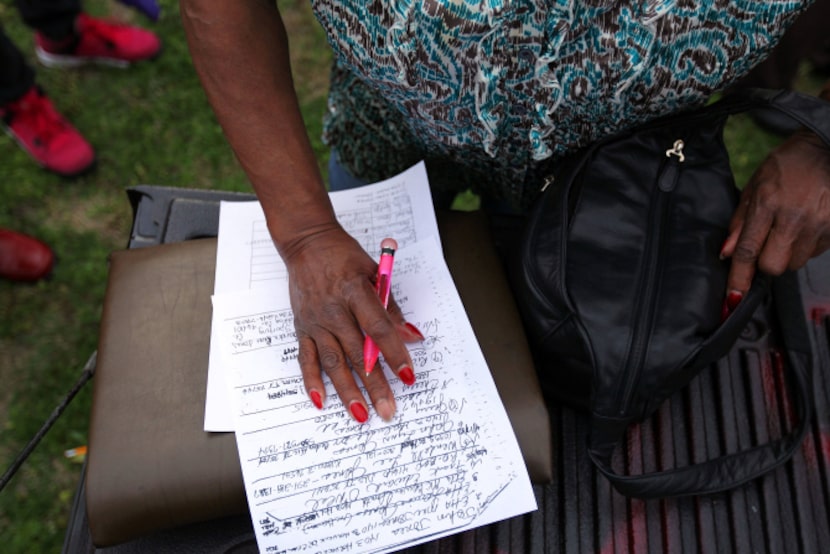 Residents and former residents of West Dallas exchange information during a community rally....