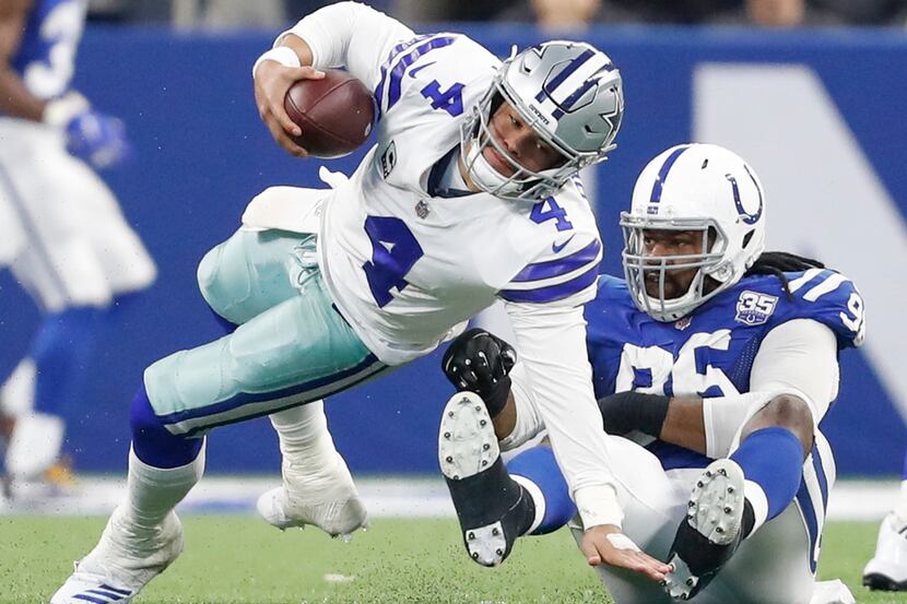 Dallas Cowboys quarterback Dak Prescott (4) is sacked by Indianapolis Colts defensive tackle...
