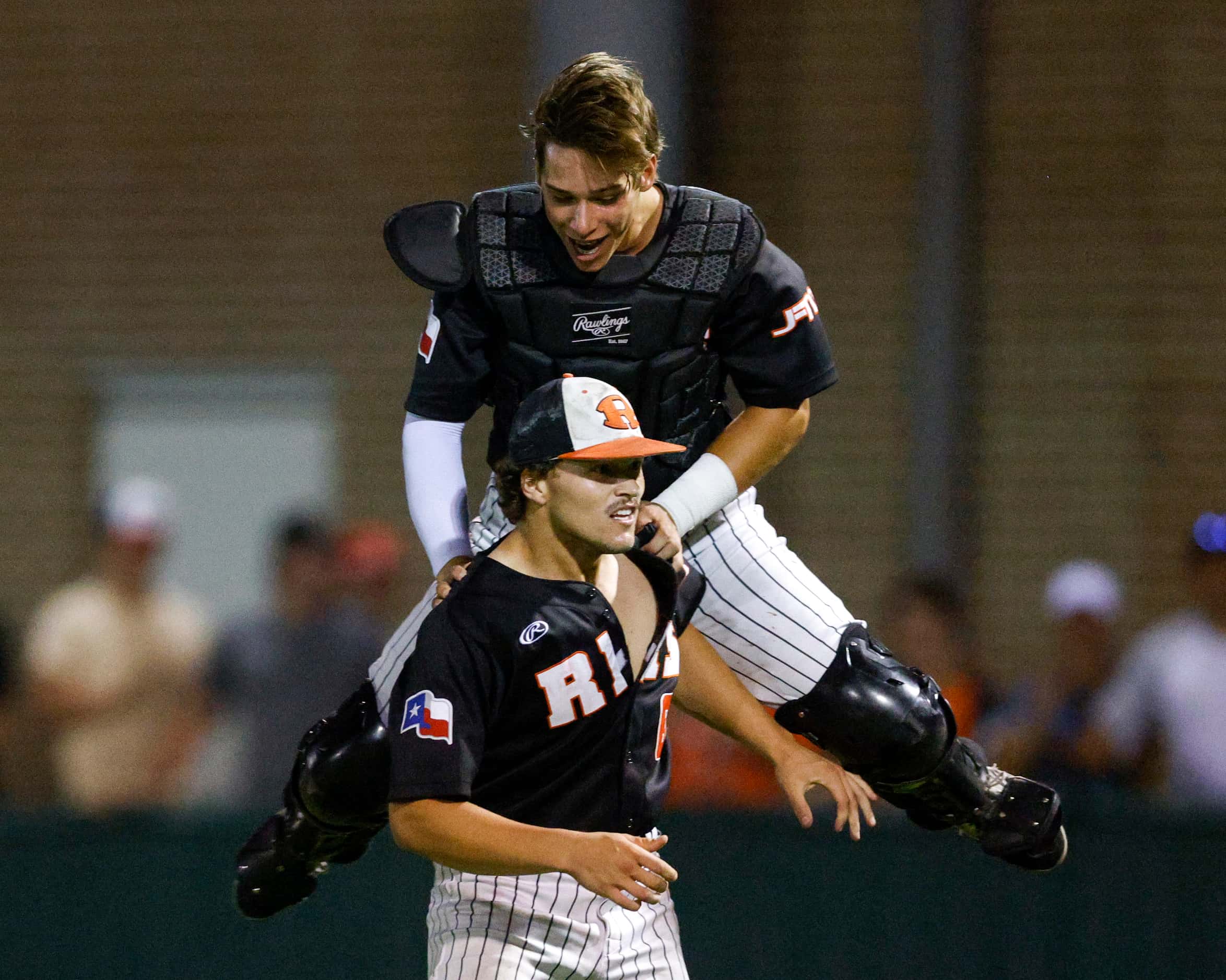 Rockwall catcher Jake Overstreet (11) celebrates with pitcher Mac Rose (6) after winning a...