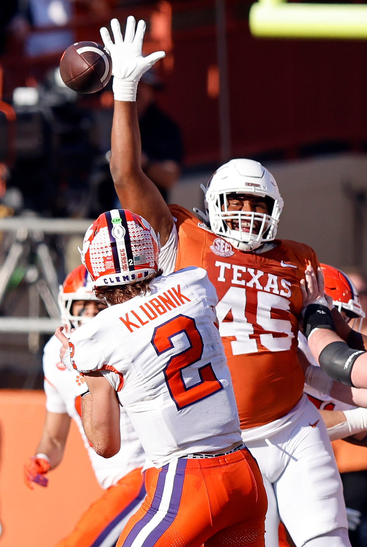 Texas Longhorns defensive lineman Vernon Broughton (45) gets a hand up on a throw by Clemson...