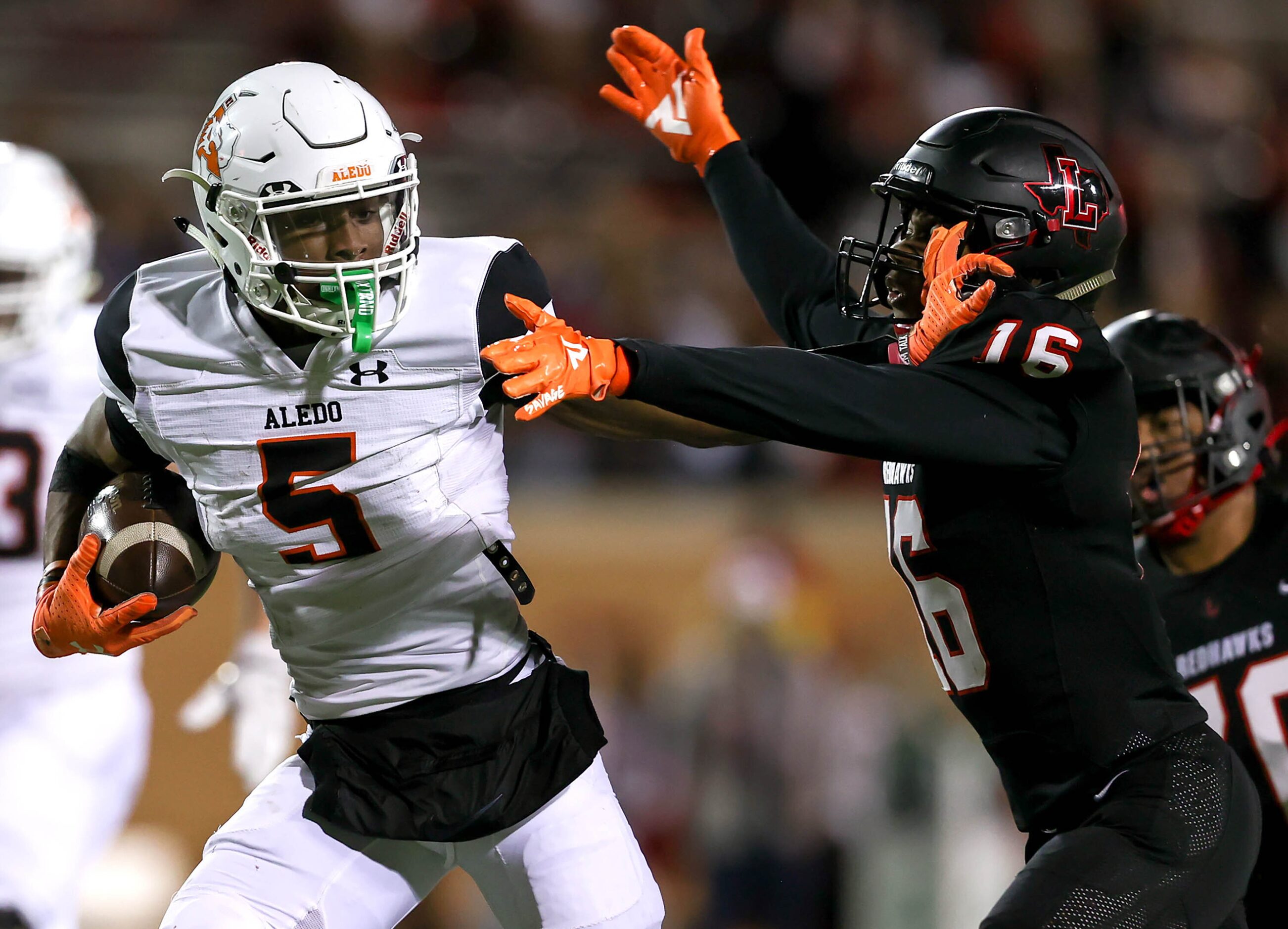 Aledo running back Ryan Williams (5) gives a stiff-arm to Frisco Liberty cornerback Cameron...