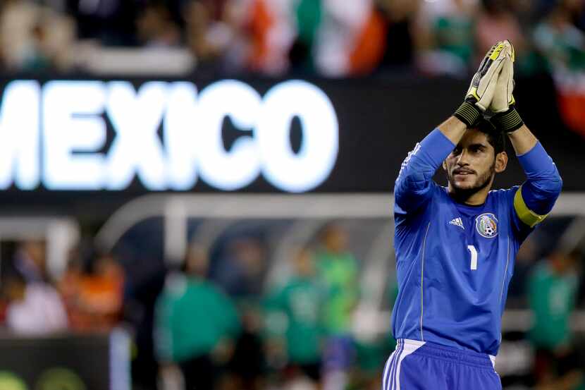 Mexico goalkeeper Jesus Corona gestures toward fans after his team beat Ivory Coast 4-1 in...