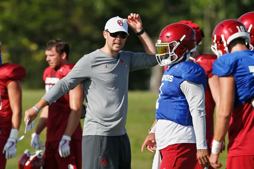 FILE - In this Monday, Aug. 6, 2018, file photo, Oklahoma head coach Lincoln Riley, left,...