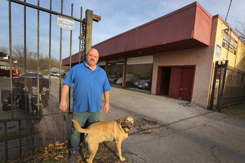Owner Kevin Prestridge of Merriman Park Automotive is pictured at his business with his dog...