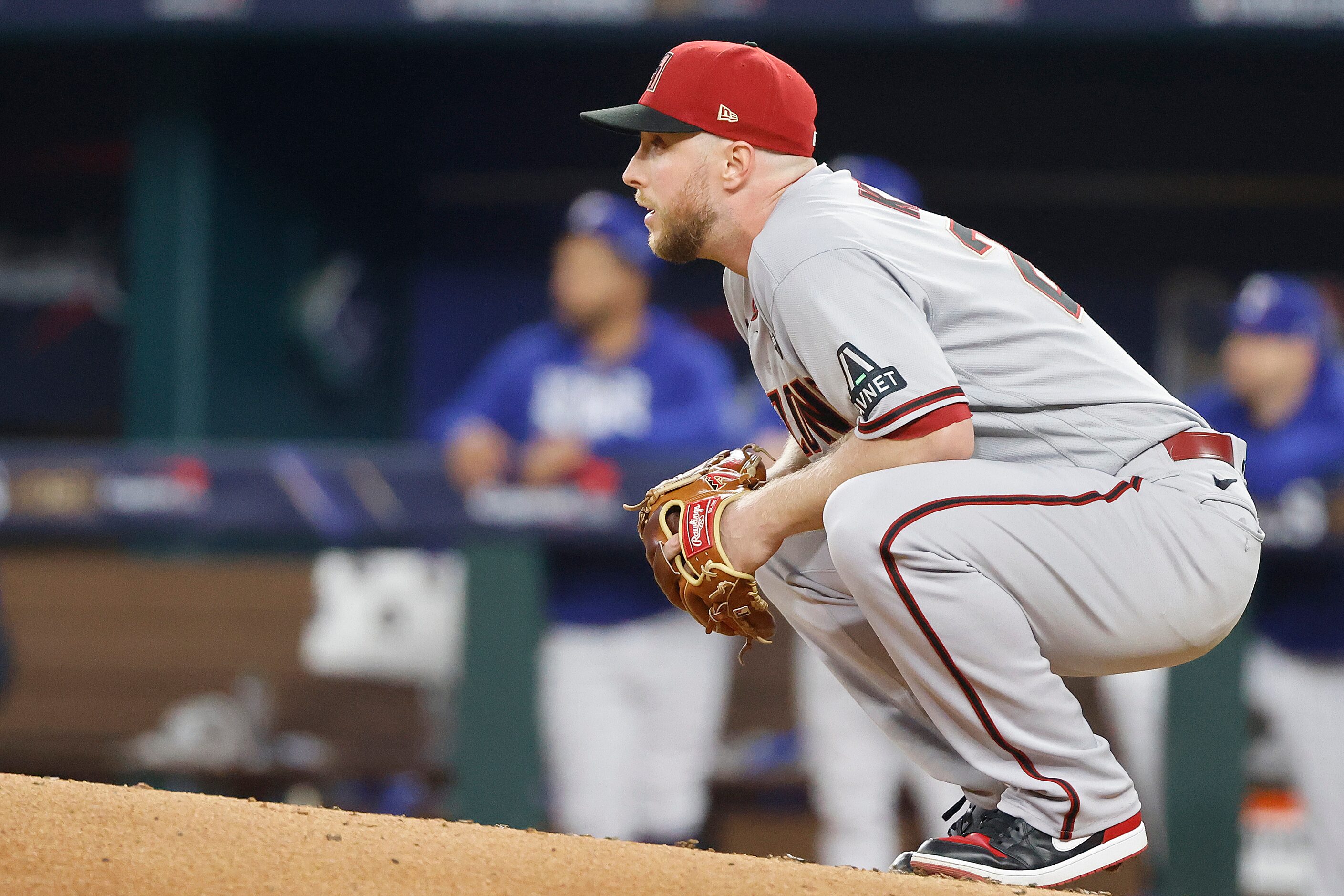 Arizona Diamondbacks starting pitcher Merrill Kelly (29) watches Texas Rangers' Evan...