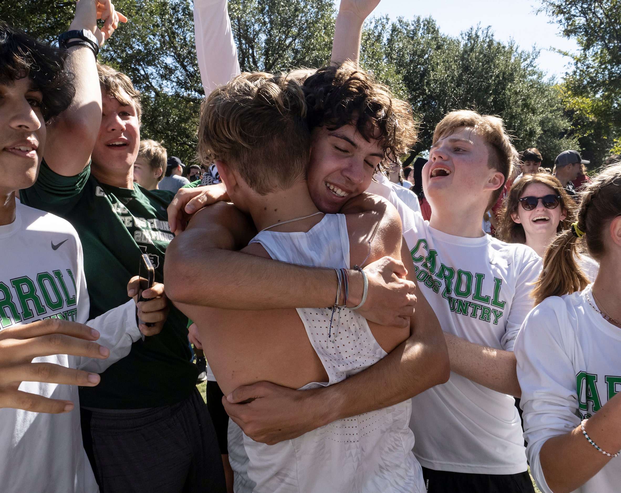 Southlake Carroll David Fisher, (2771), center, is hugged by teammate,Logan Cantu, (2770),...