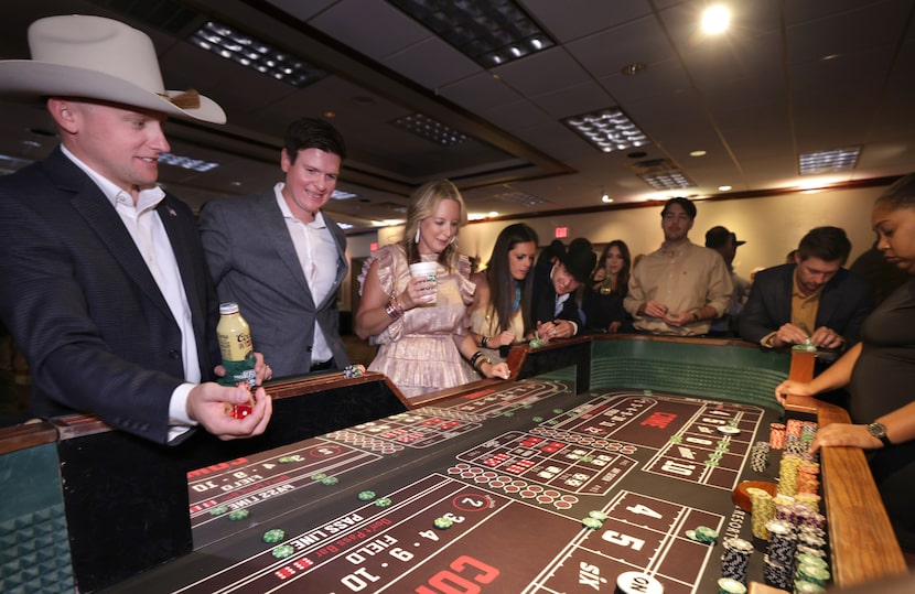 Guests enjoy the charity casino area during the Cattle Baron's Ball at Southfork Ranch in...