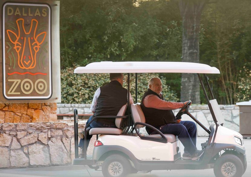 Dallas Zoo president drives a cart with Harrison Edell, executive vice president of animal...