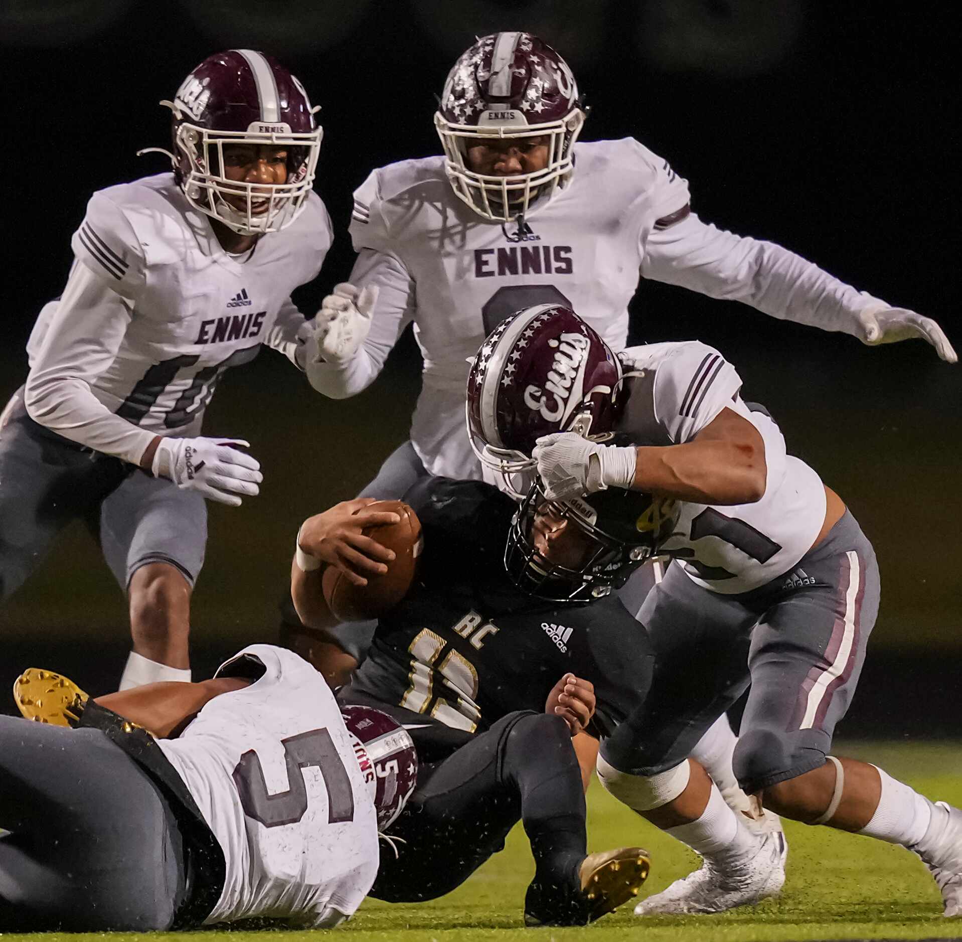 Royce City quarterback Kenneth Spring (13) is dropped for a loss by Ennis linebackers  Edgar...