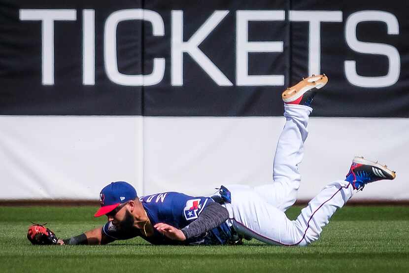 Texas Rangers right fielder Nomar Mazara makes a diving catch on a ball off the bat of...
