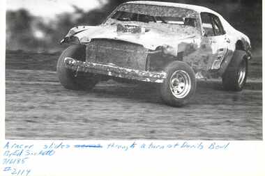 1985 photo of a car racing at the Devil's Bowl Speedway in Mesquite.