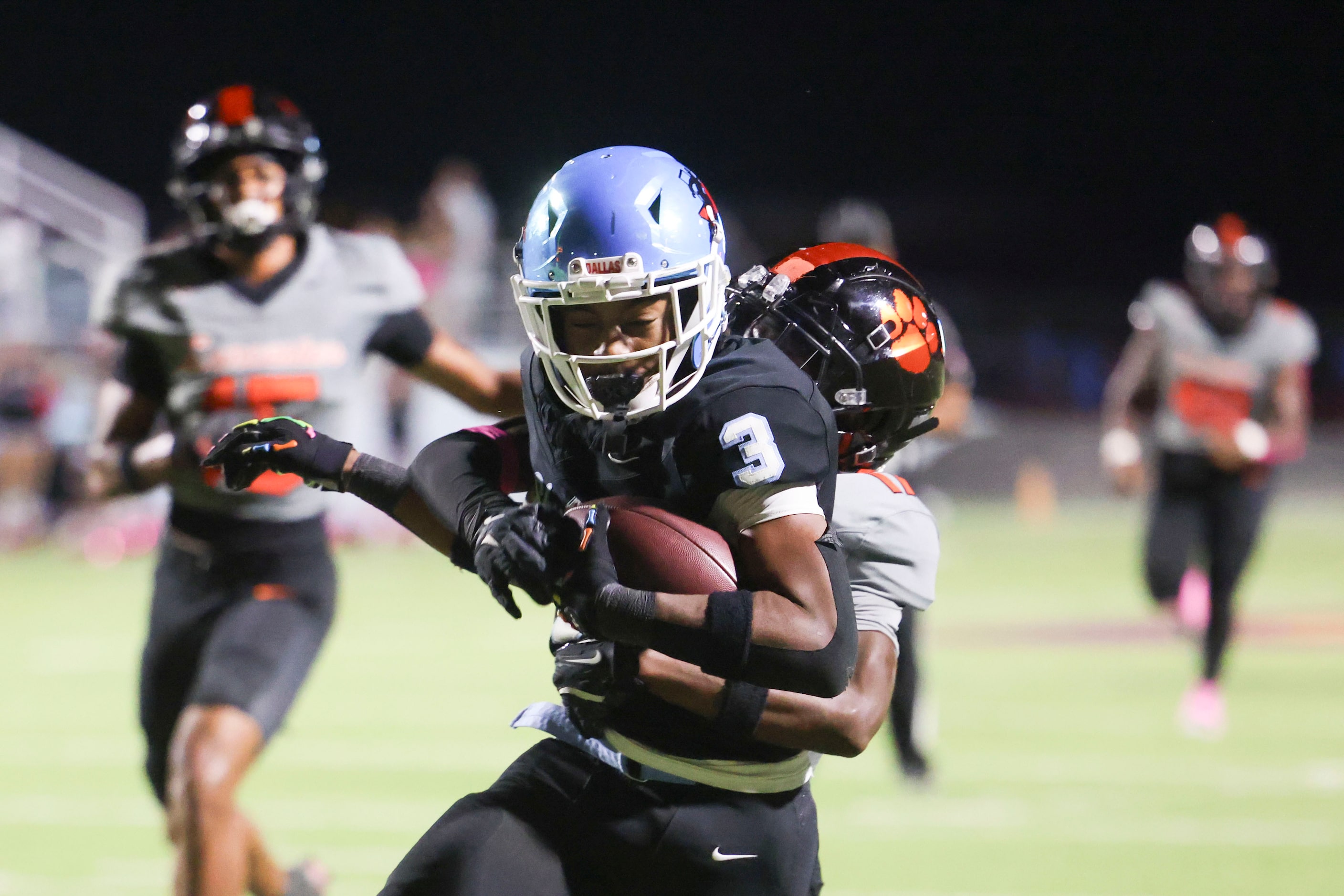 Skyline High’s Delvin Cook (3) scores a touchdown past Lancaster High’s Kainen Jones during...