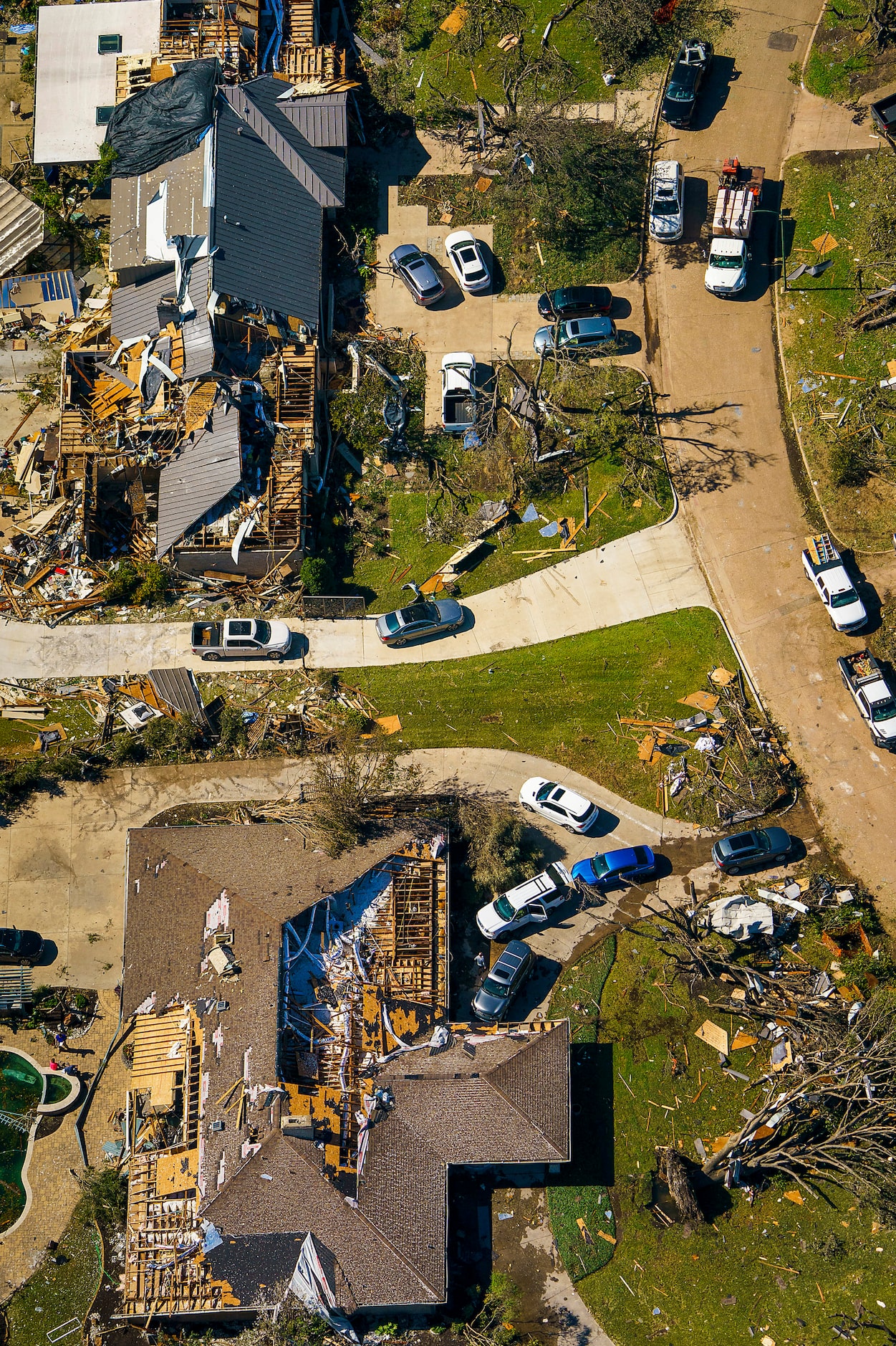 People work amidst tornado damage near Walnut HIll Lane and Mash Lane in Monday, Oct. 21,...