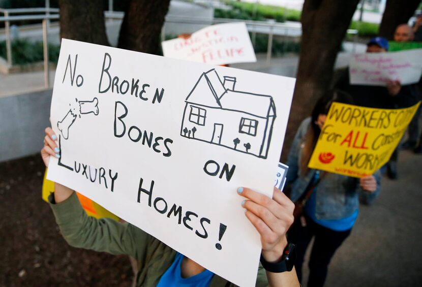 Protesters carry signs in Uptown Dallas on Monday, February 24, 2020. Marco was injured on...