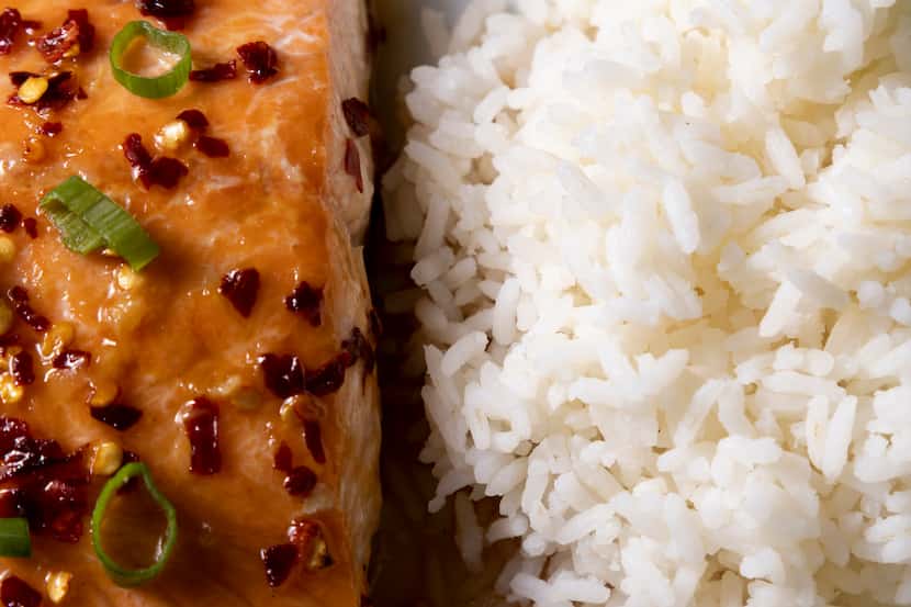 Serve Spicy-Sweet Baked Salmon with rice and lime wedges.