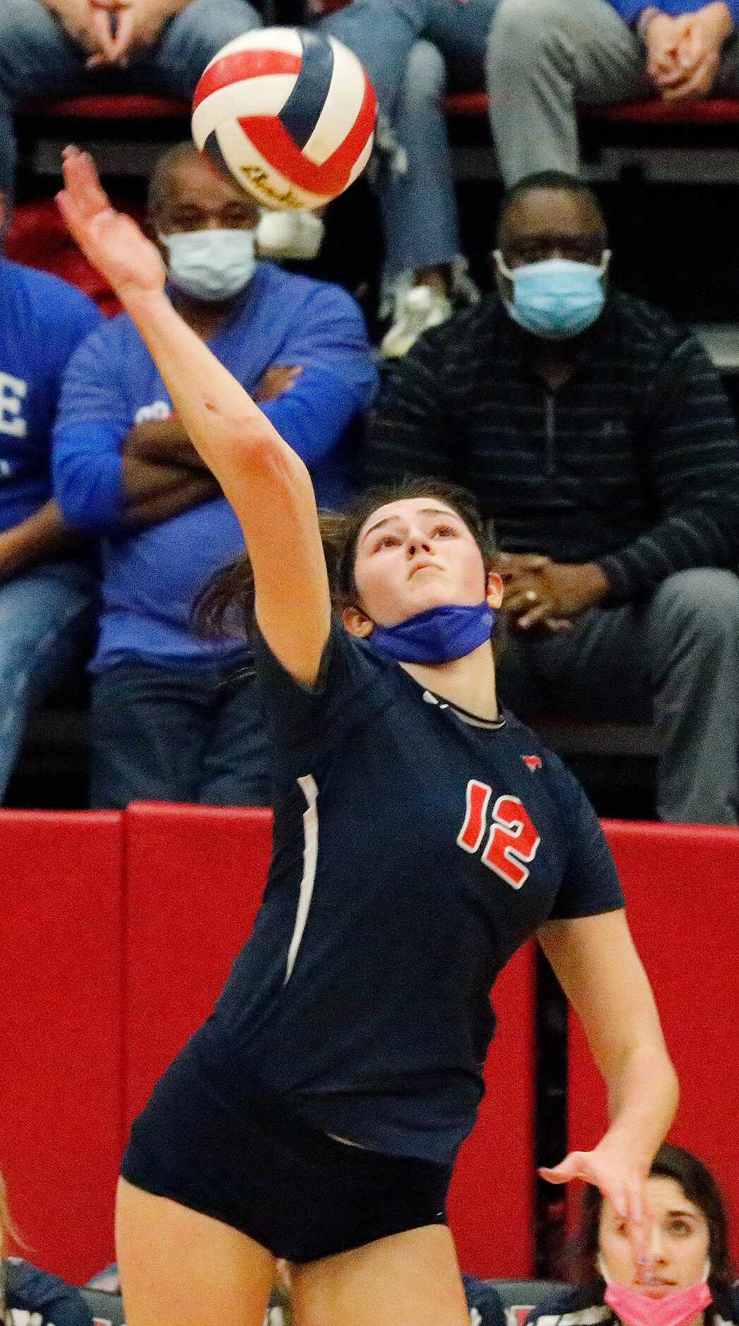 Grapevine High School outside hitter Janet DeMarris (12) makes a hit during game two as...
