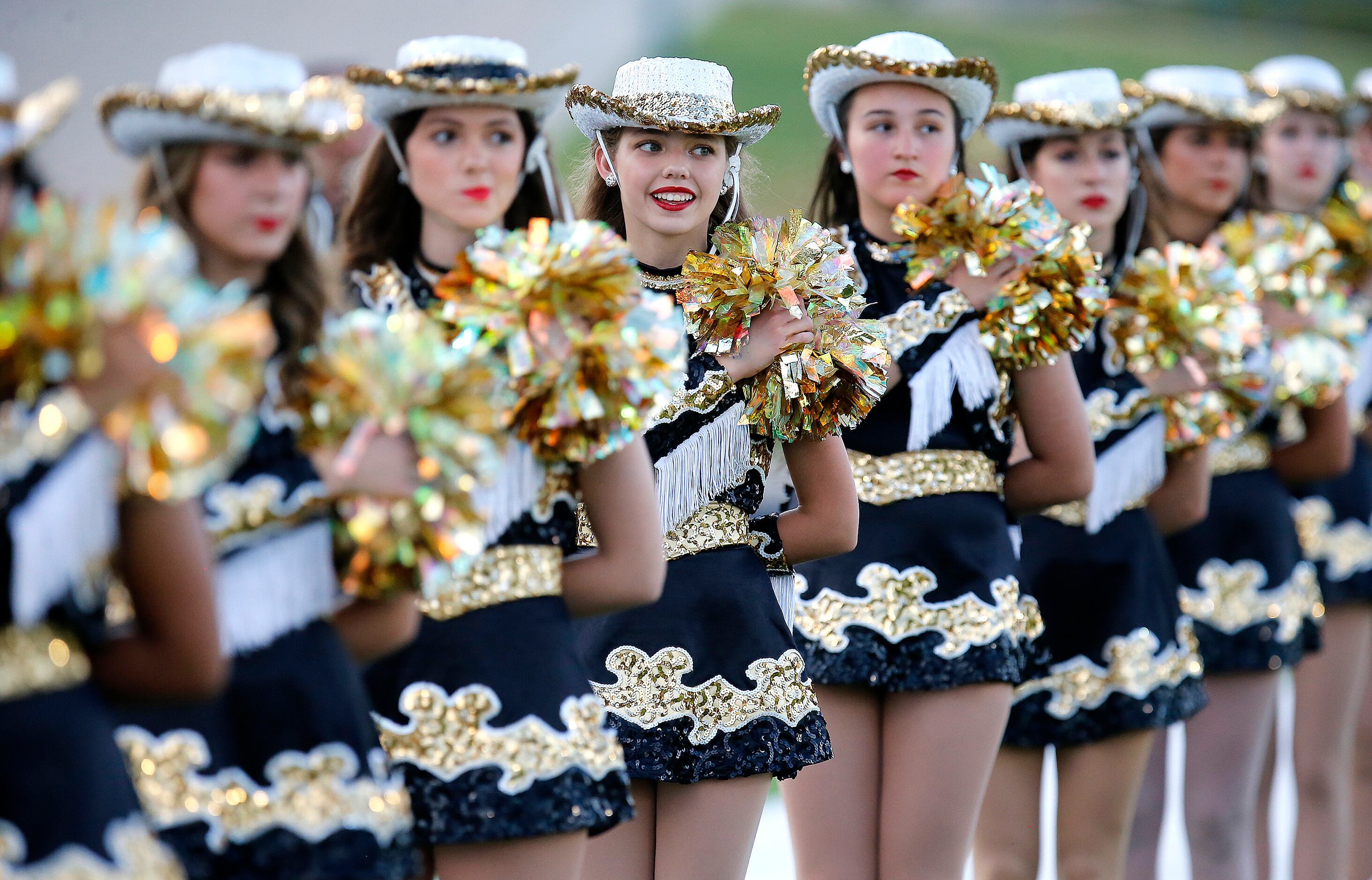 Plano East High School Golden Girl Evie Pugliese (center) waits with the drill team for the...