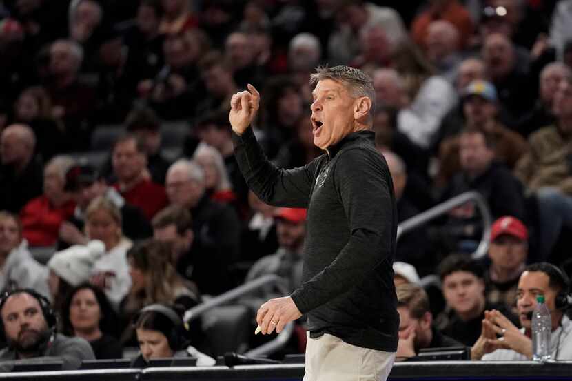 Oklahoma head coach Porter Moser calls from the sideline during the first half of an NCAA...