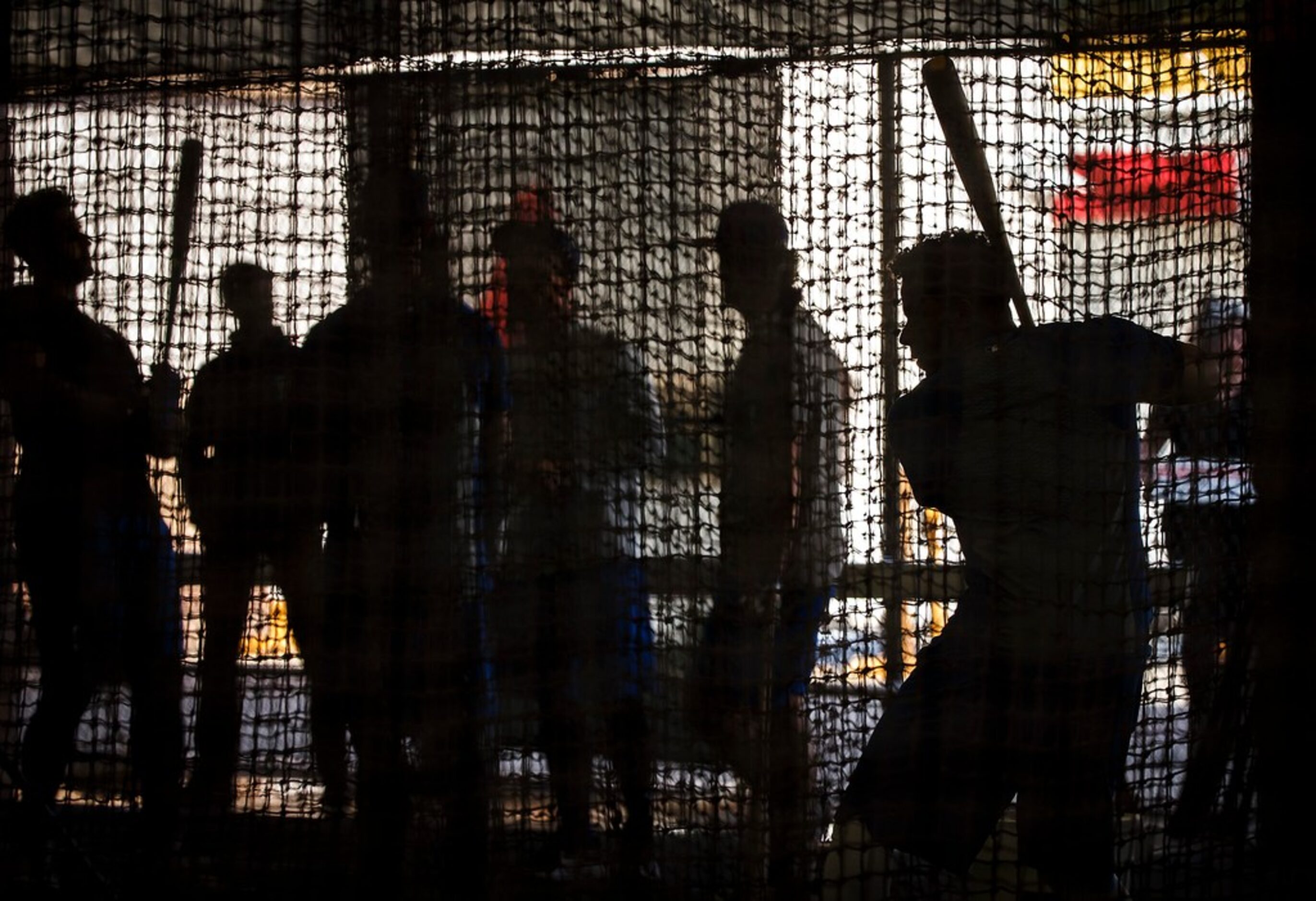 Texas Rangers shortstop Elvis Andrus (right) hits in the batting cages during a spring...