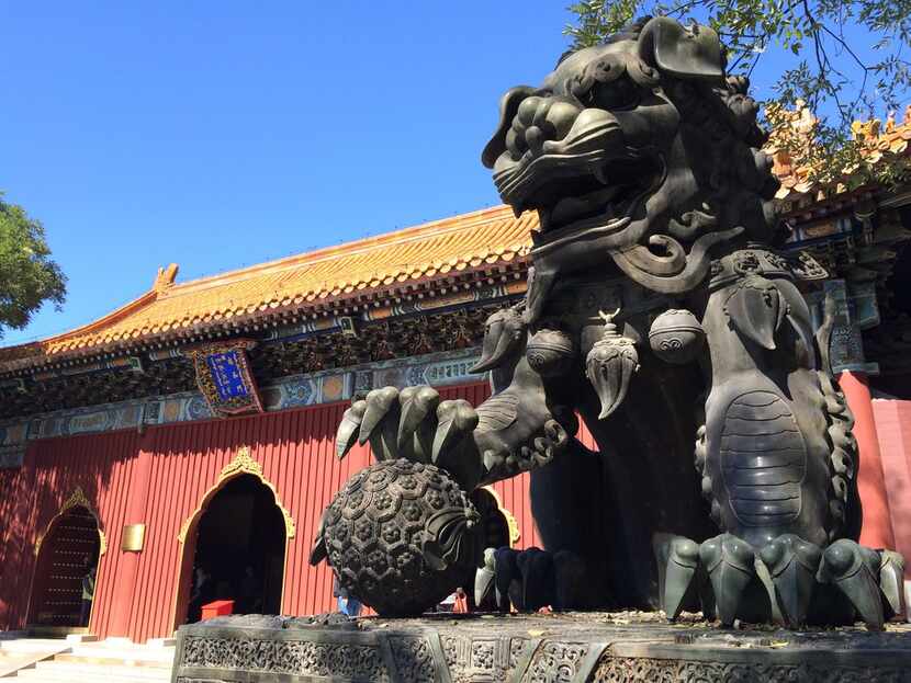 The statue of a dragon-like beast guards one of the buildings at Yonghe Temple in Beijing in...