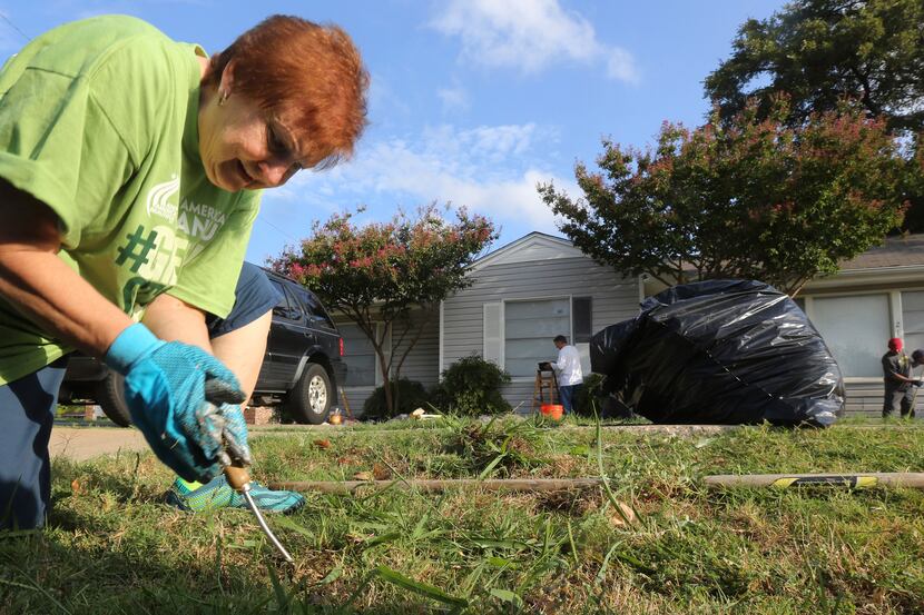 Glenna Brown digs up some weeds in front of the Harmony House in Garland. Keep Garland...