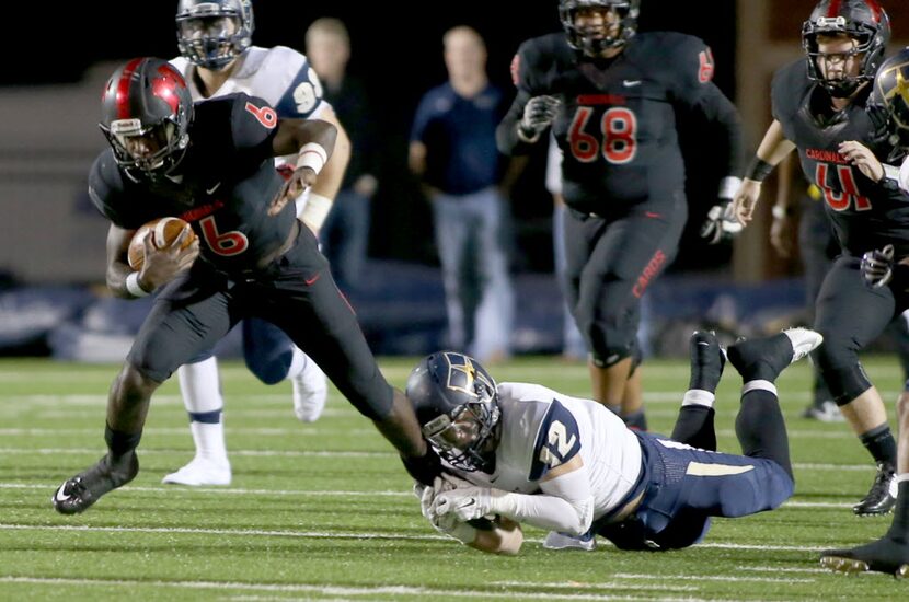 Irving MacArthur’s Artiss Henderson (6) has a shoe string tackle made on him by Jesuit’s...