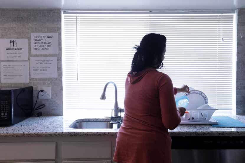 Muna (last name withheld by request) washes dishes at an ICNA Relief Transitional House in...