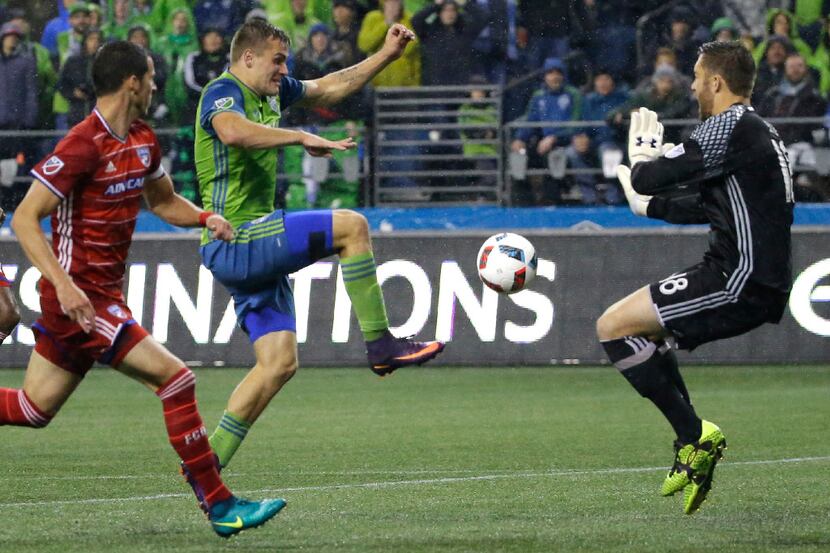 Seattle Sounders forward Jordan Morris, second from left, makes a close shot that was...