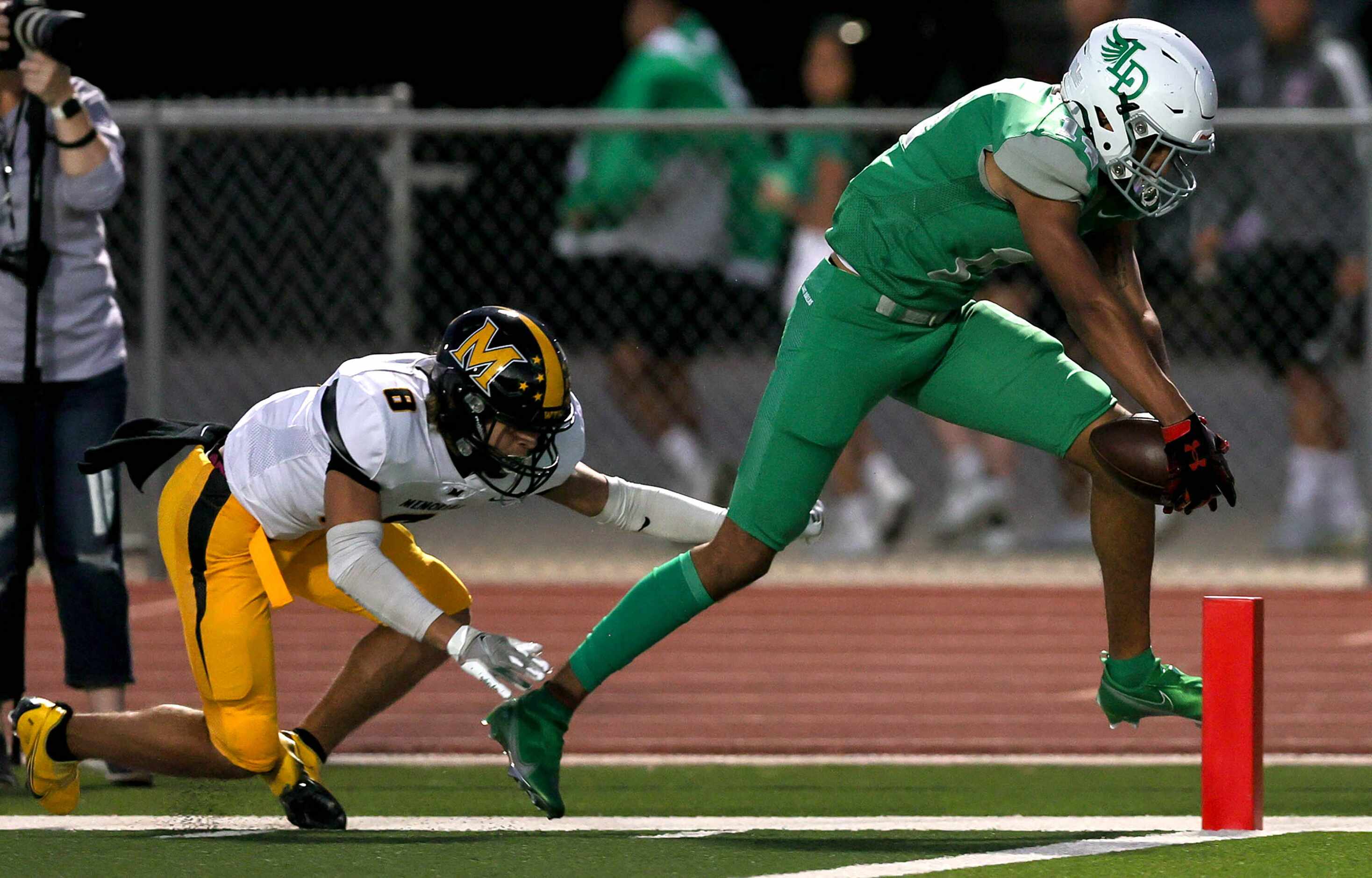 Lake Dallas wide receiver Evan Weinberg (R) gets across the goal line for a touchdown...