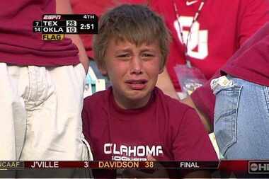 Jonah Israel, 11, weeps on camera as the Oklahoma Sooners fell to Texas 28-10 during the...