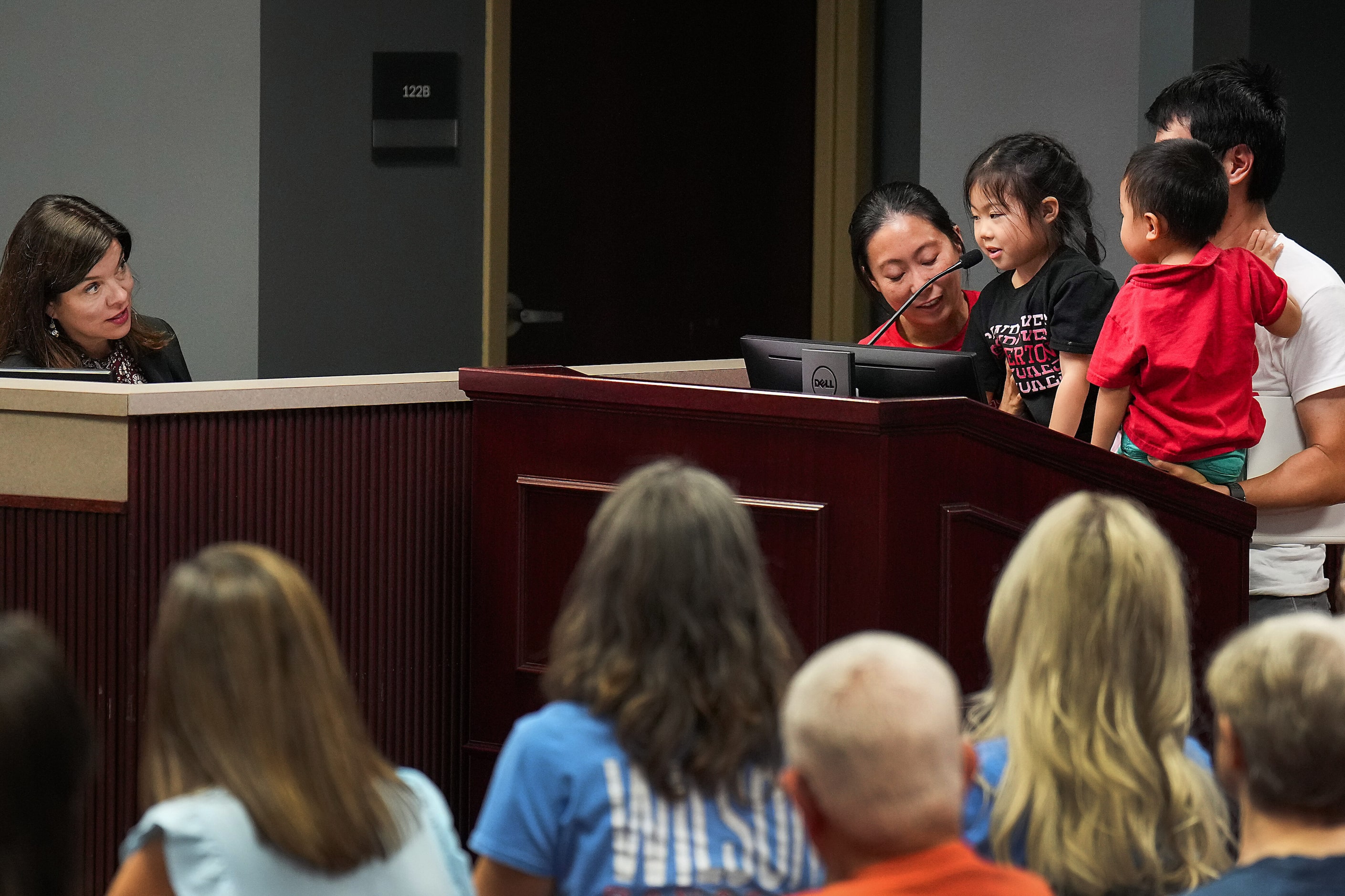 Coppell ISD school board member Leigh Walker (left) listens to public comment from Pinkerton...