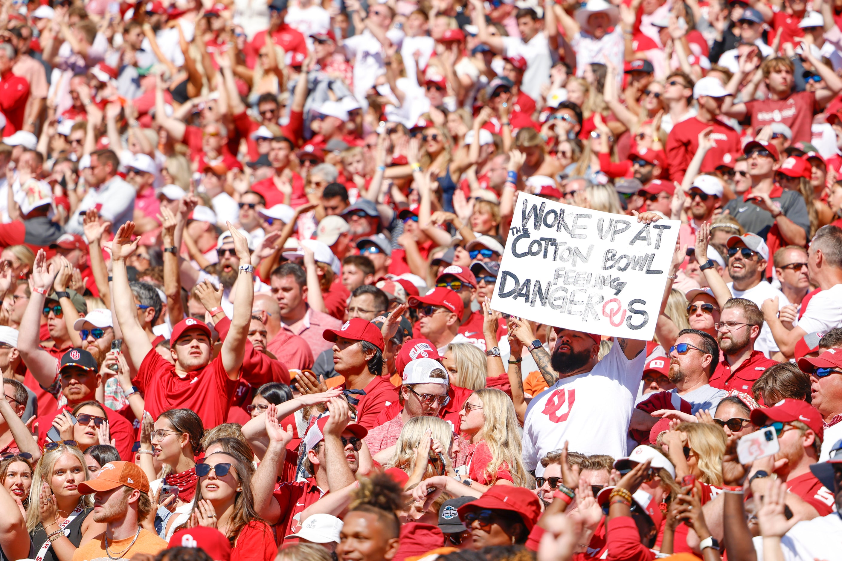 An Oklahoma fan holds up a sign during the second half of the Red River Rivelry at the...