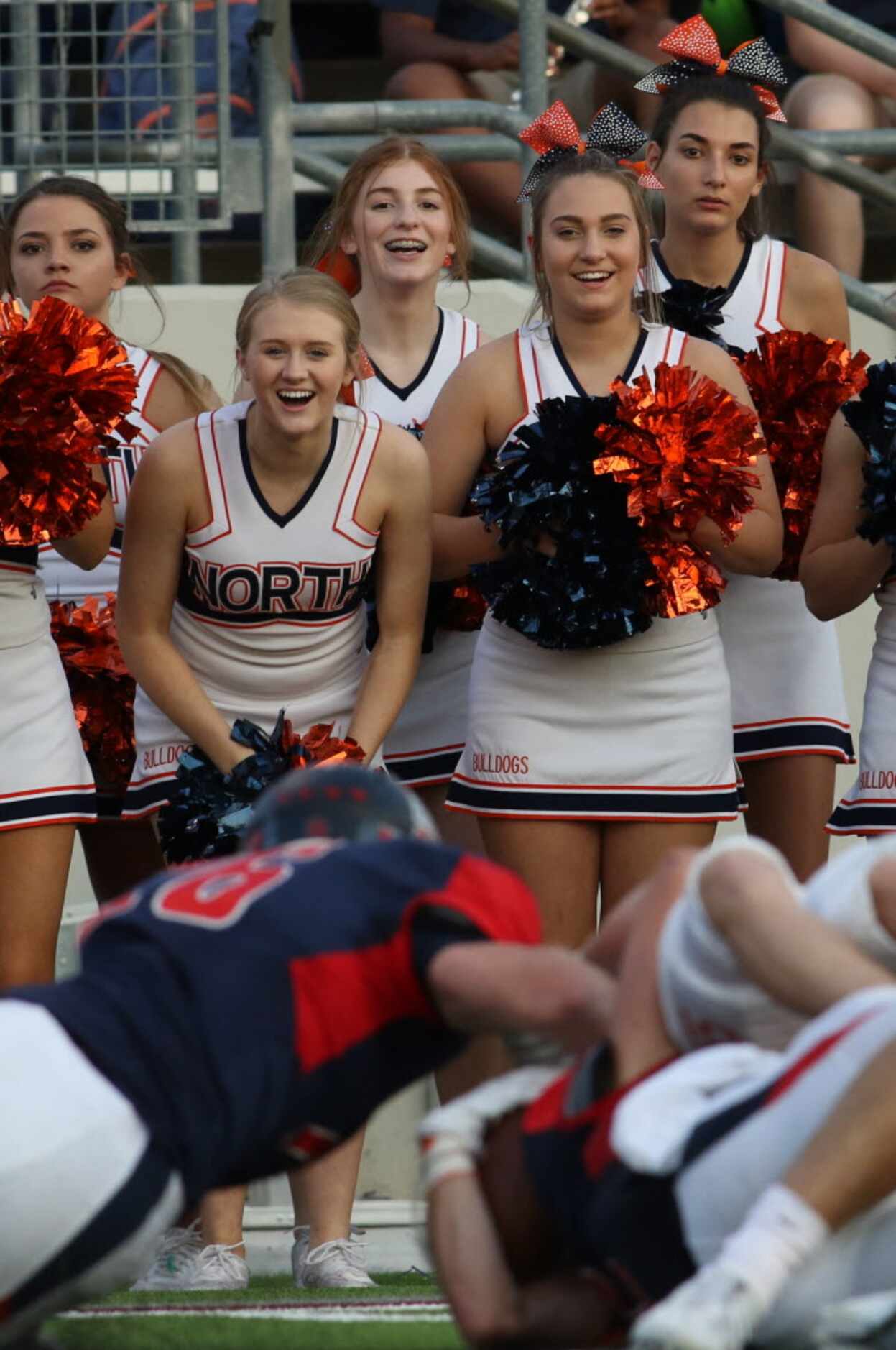 Members of the McKinney North cheerleaders squad delight in a first quarter first down by...