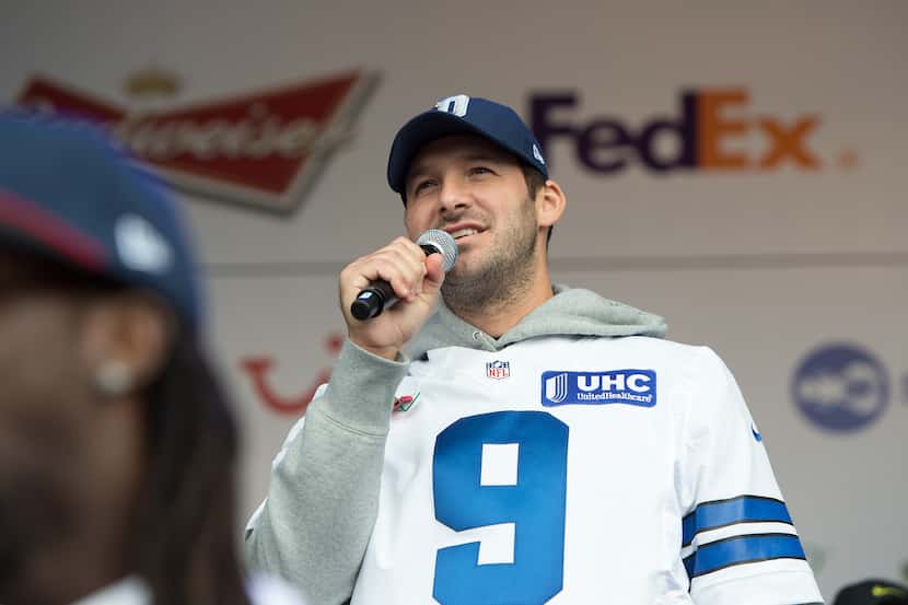 Dallas Cowboys quarterback Tony Romo speaks on stage during the NFL Fan Rally outside...