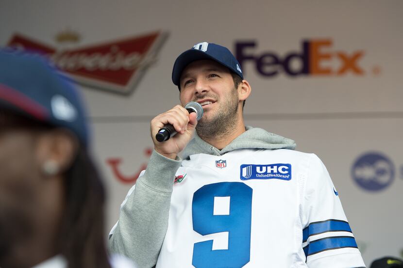 Dallas Cowboys quarterback Tony Romo speaks on stage during the NFL Fan Rally outside...