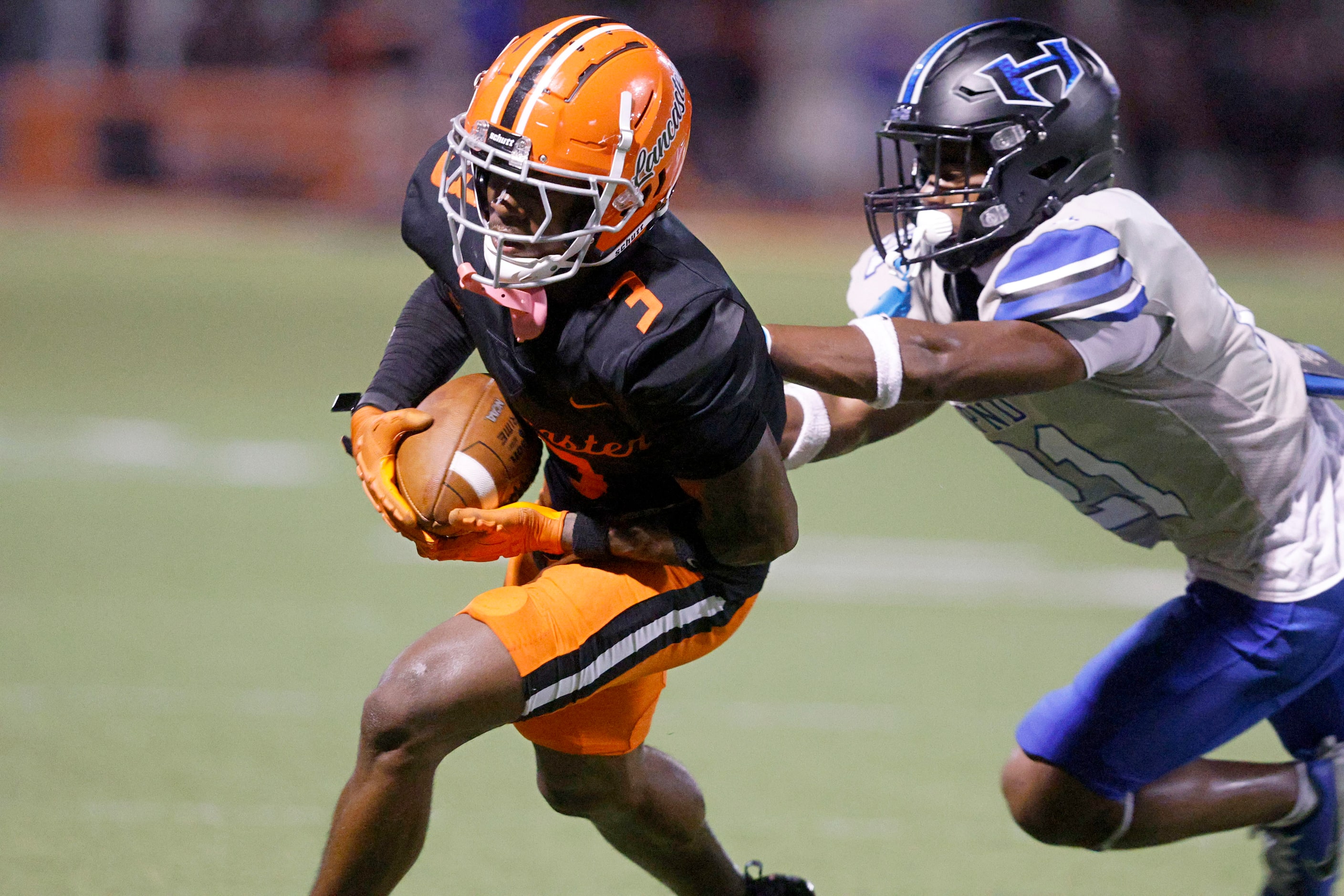 Lancaster’s Ja’Quavius Pipkin (3) carries the ball against Hebron’s Aaron McCardell, right,...