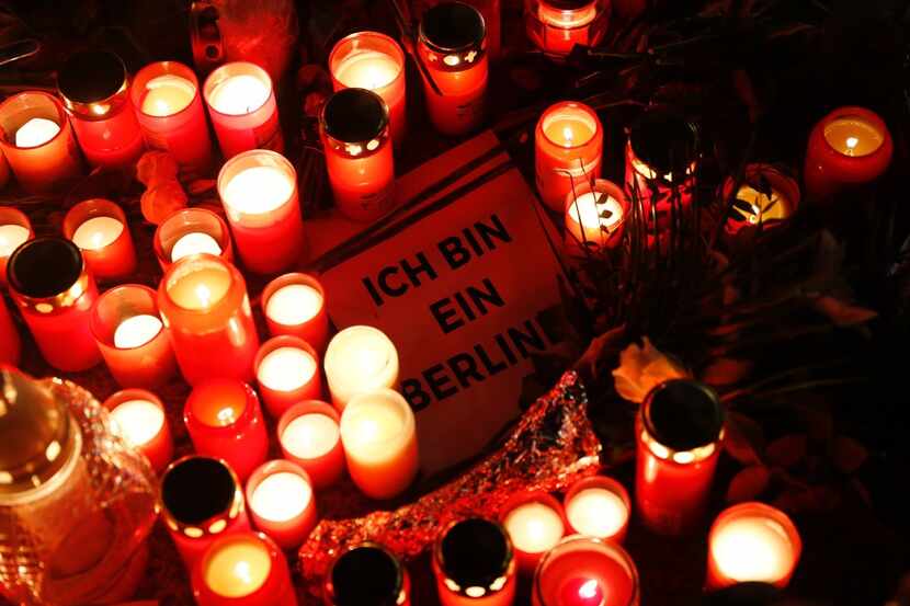 A sign quoting John F Kennedy's sentence "I am a Berliner" lies inmid candles at a makeshift...