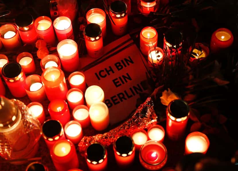 A sign quoting John F Kennedy's sentence "I am a Berliner" lies inmid candles at a makeshift...