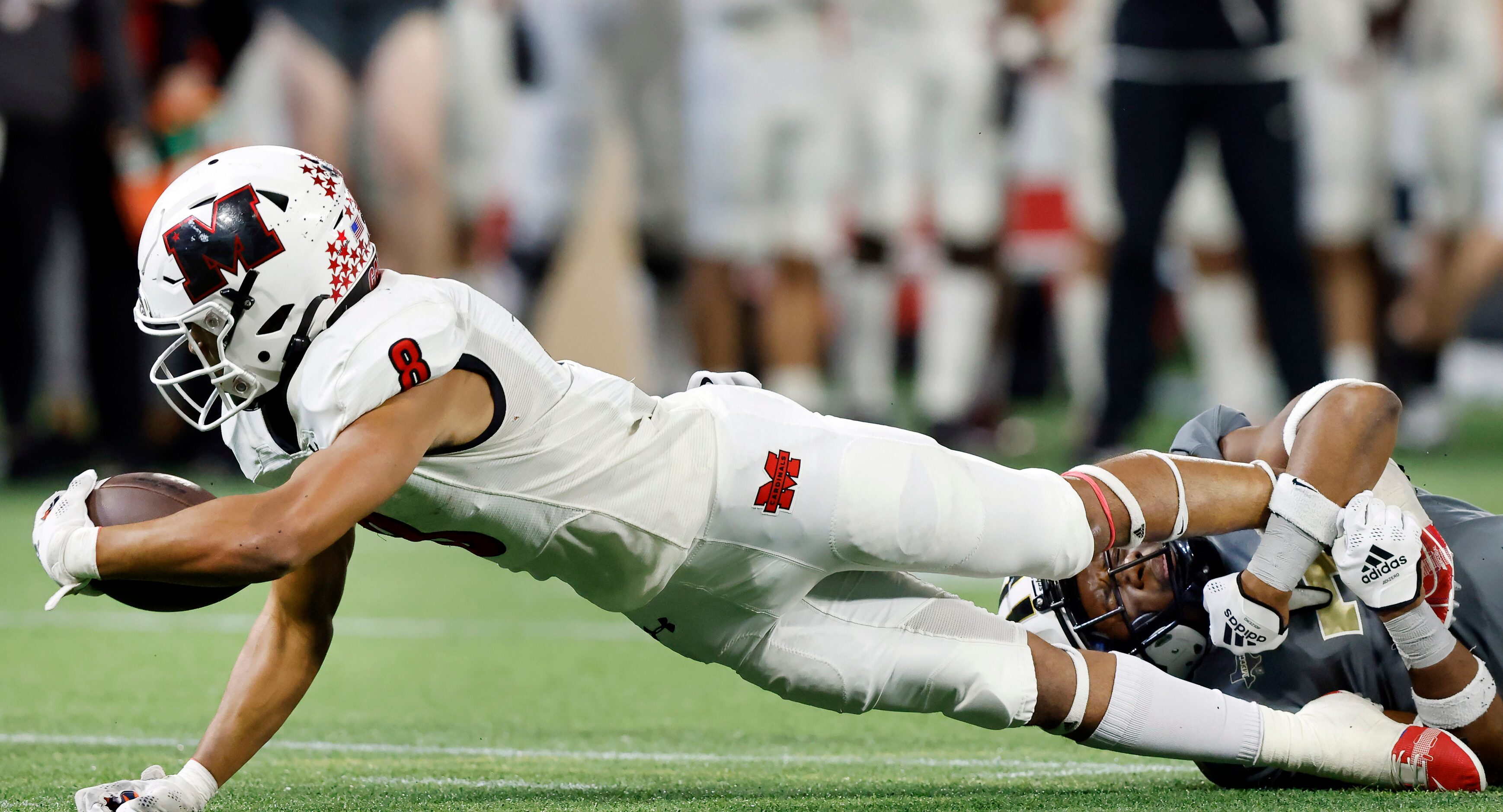 Melissa wide receiver Jacob Fields (8) dives for extra yards as he’s brought down by South...