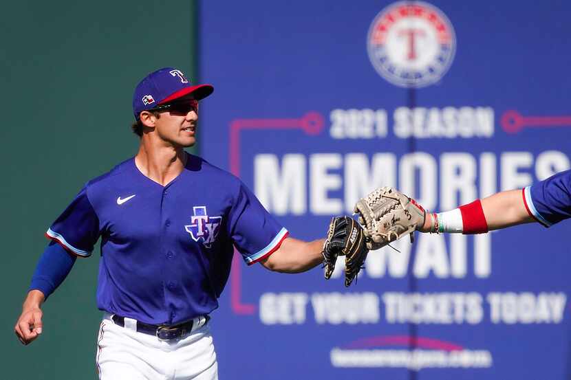 Texas Rangers outfielder Eli White celebrates after making a catch on a deep line drive off...